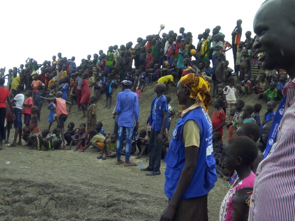 Photo of the South Sudanese audience during an event, children and adults, together with IOM operators.